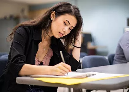 student writing in notebook
