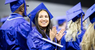 New Madison College graduate in regalia at commencement