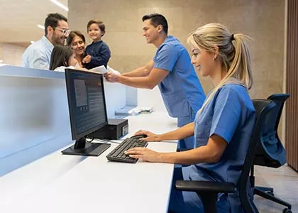 Healthcare receptionist checking in patient
