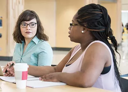 Two students sitting at a table.
