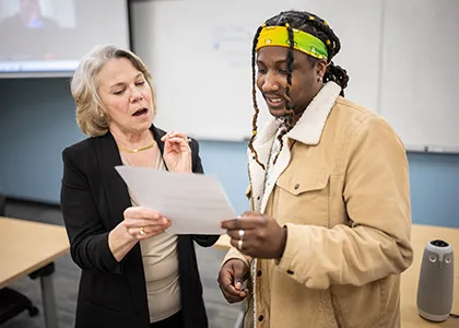 HR faculty going over paperwork with a student