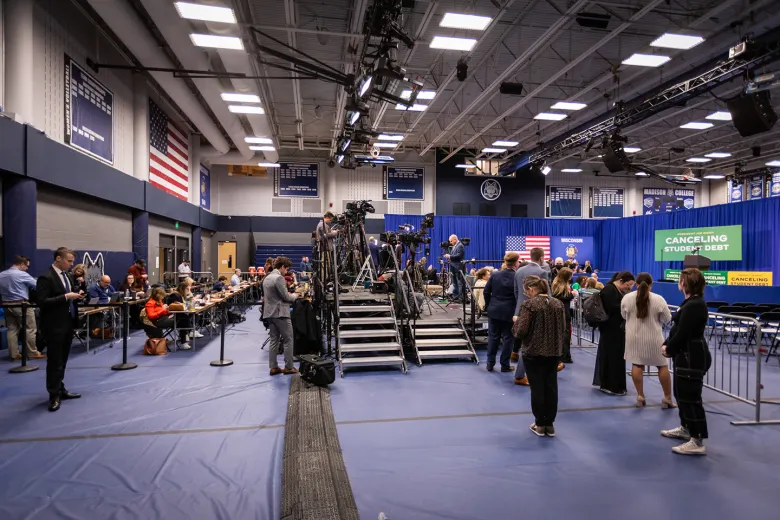 Side view of a stage with people waiting around it