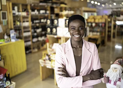An entrepreneur standing in front of their storefront.